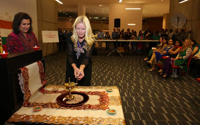 Marni Walden lighting a diya.