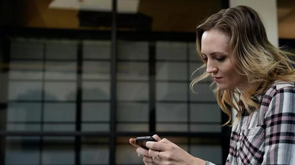 Woman looking at phone.