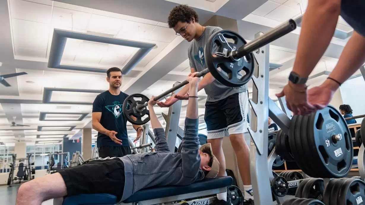 Dr. Ray Pastore, Left, Spots A Student In The Gaming Club And Esports Team On The Bench Press At The UNCW Student Recreation Center In Wilmington, NC.| Professional Gamer