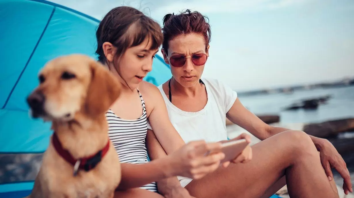 Daughter And Mother Looking At Phone | Family Road Trip