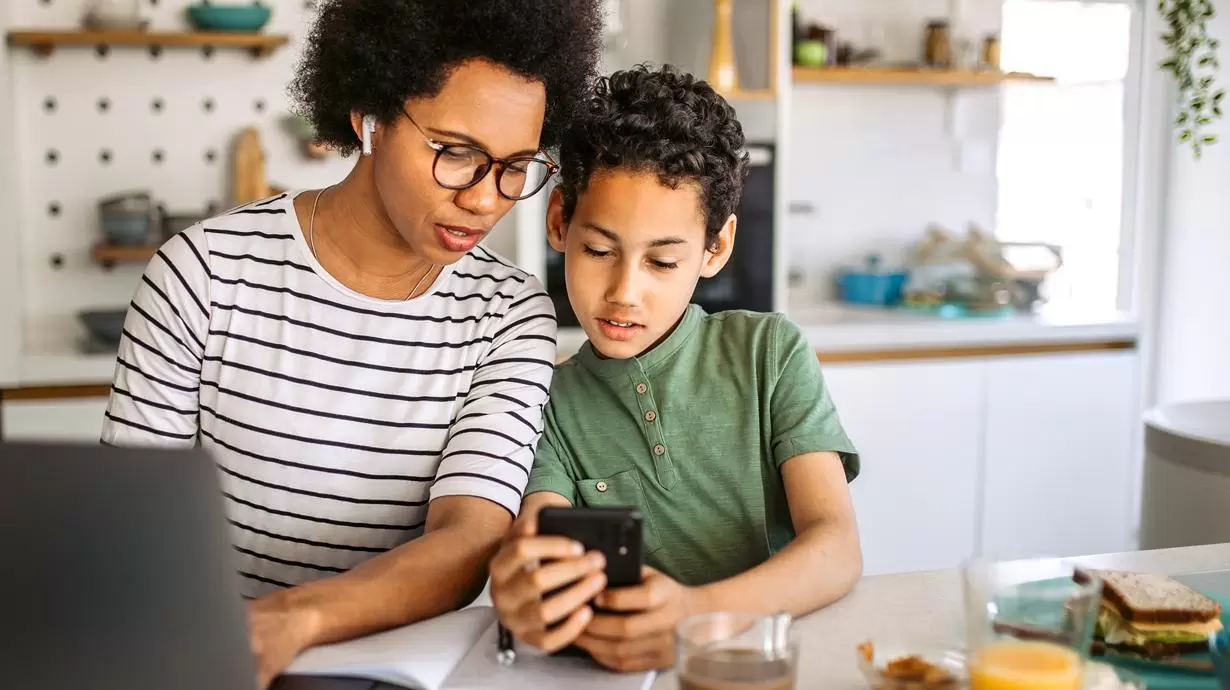 Mother Explaining To Son How To Retrain Social Media Algorithm