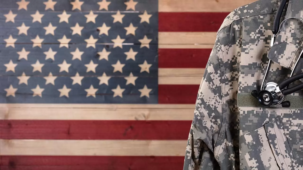 Military doctor in front of U.S. flag