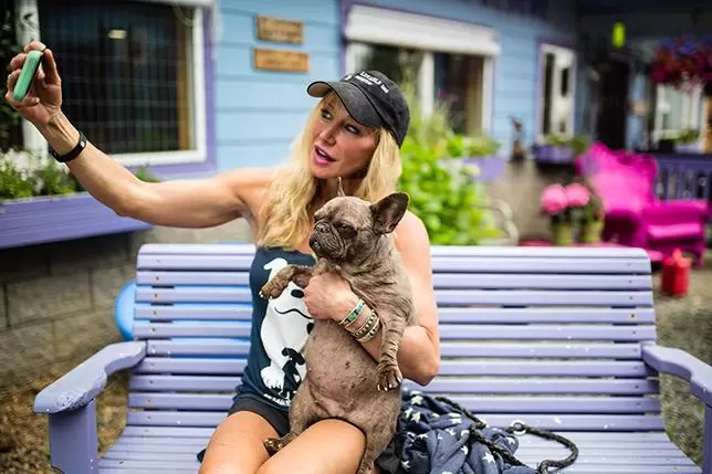 Woman taking selfie with dog